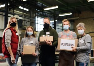 Non-profit volunteers hold up packages