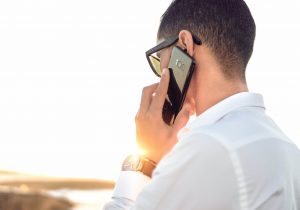 Person takes a call on a mobile phone while outside